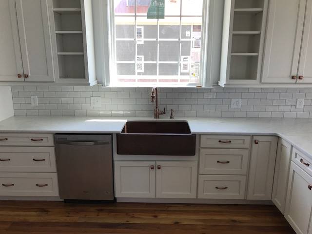 Complementary: White cabinetry with light countertops and backsplash.